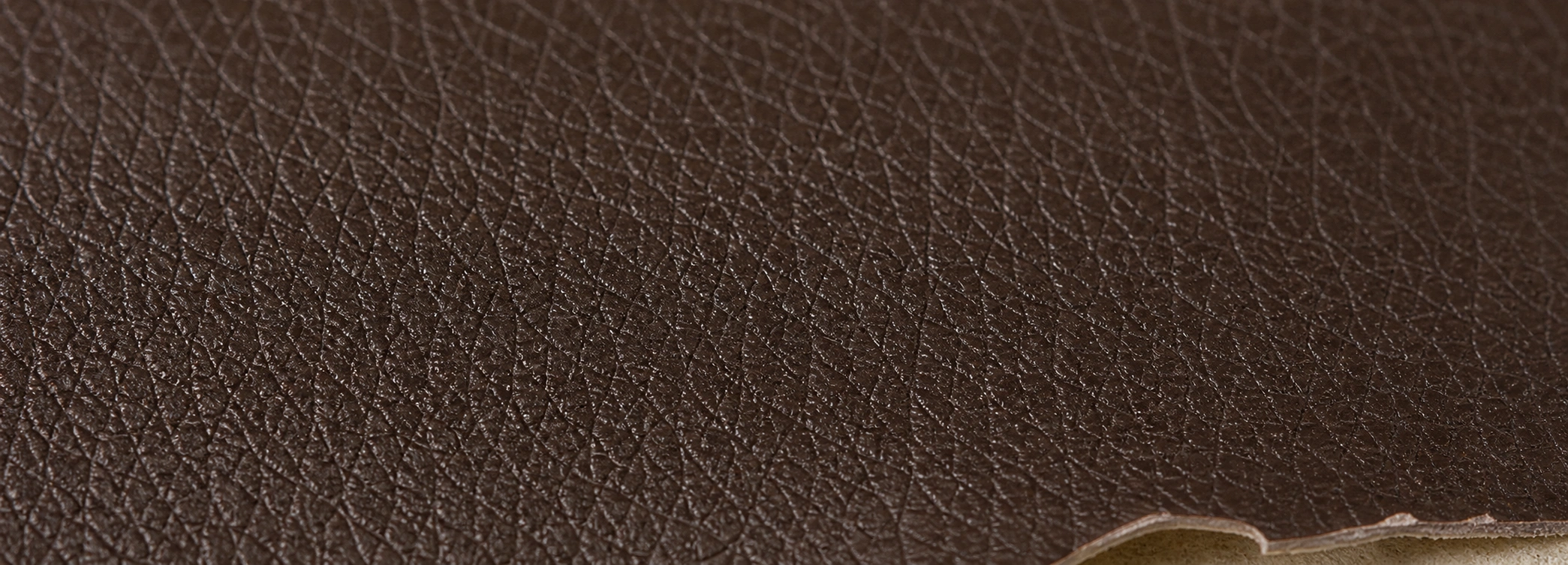 Bonded leather surface showing uniform synthetic appearance with pressed grain pattern