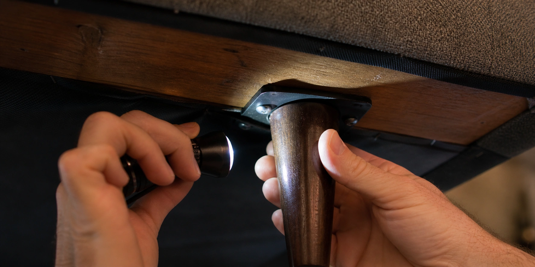 Inspecting sofa leg attachment point to diagnose looseness