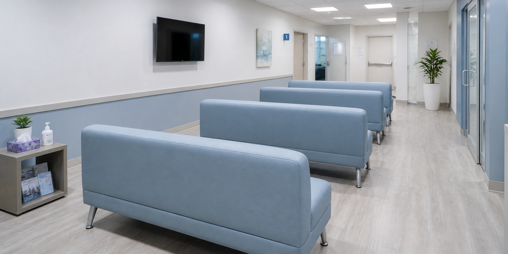 Clean medical office waiting room with durable vinyl sofas arranged in neat rows