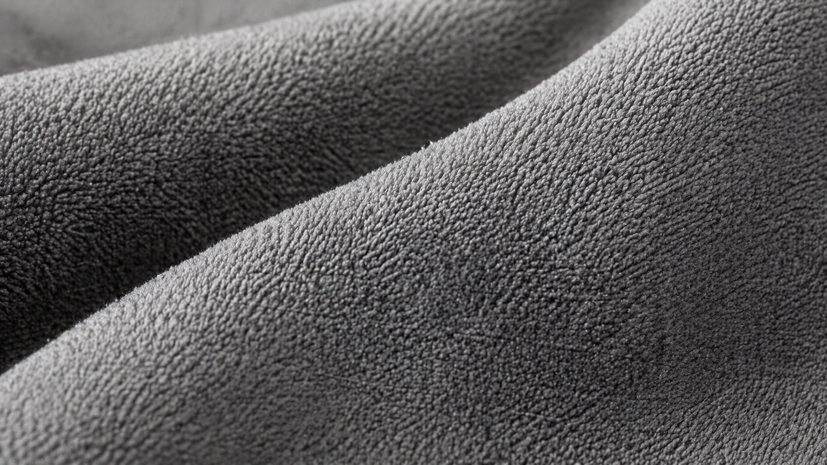 Close-up texture of microfiber sofa fabric showing fine fibers