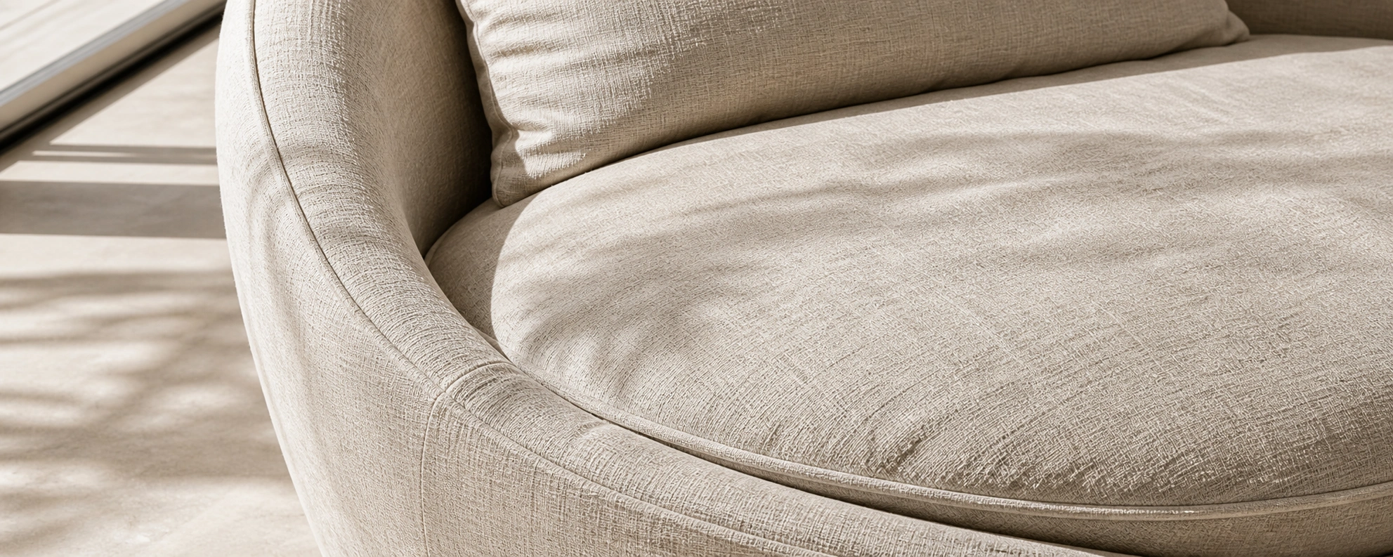 Round linen sofa in beige with natural textured weave