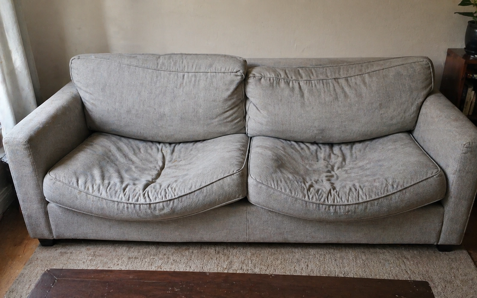 Sagging cushions on a cheap budget sofa after two years of use