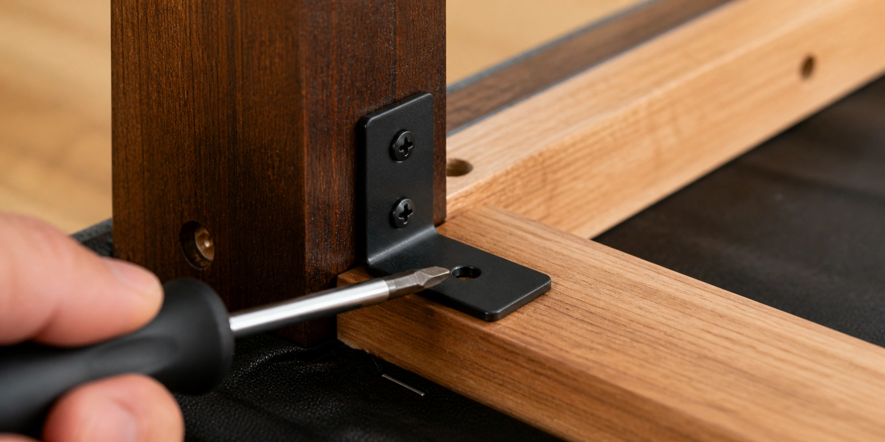 Metal corner brackets reinforcing sofa leg to frame connection