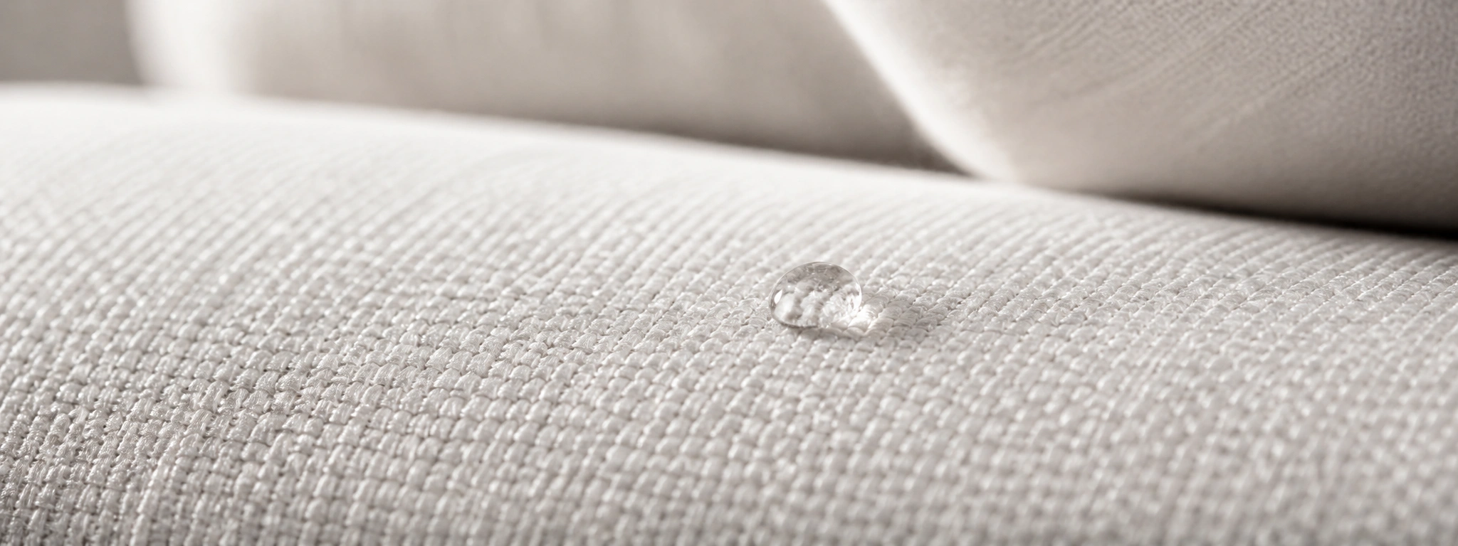 Close-up texture of white performance fabric upholstery on a sofa